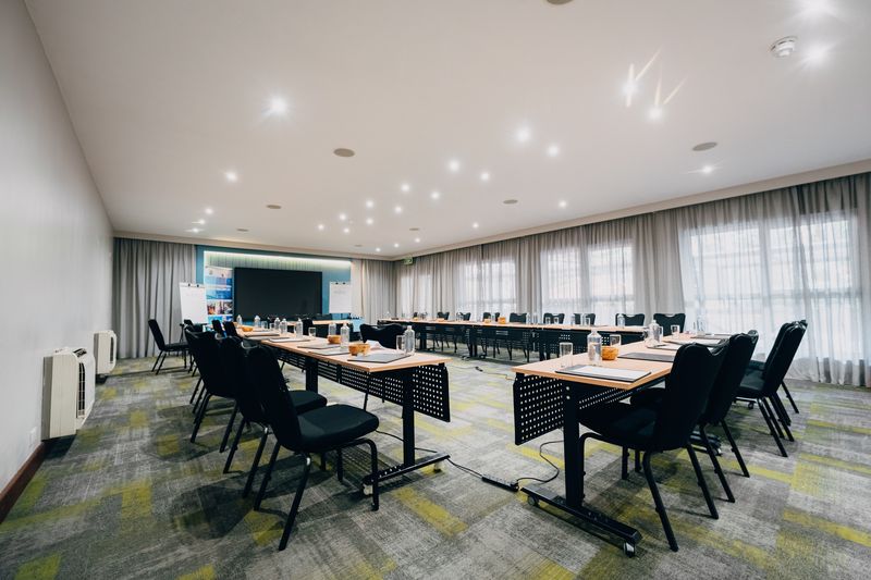 U-shaped seminar setup with notepads and bottled water