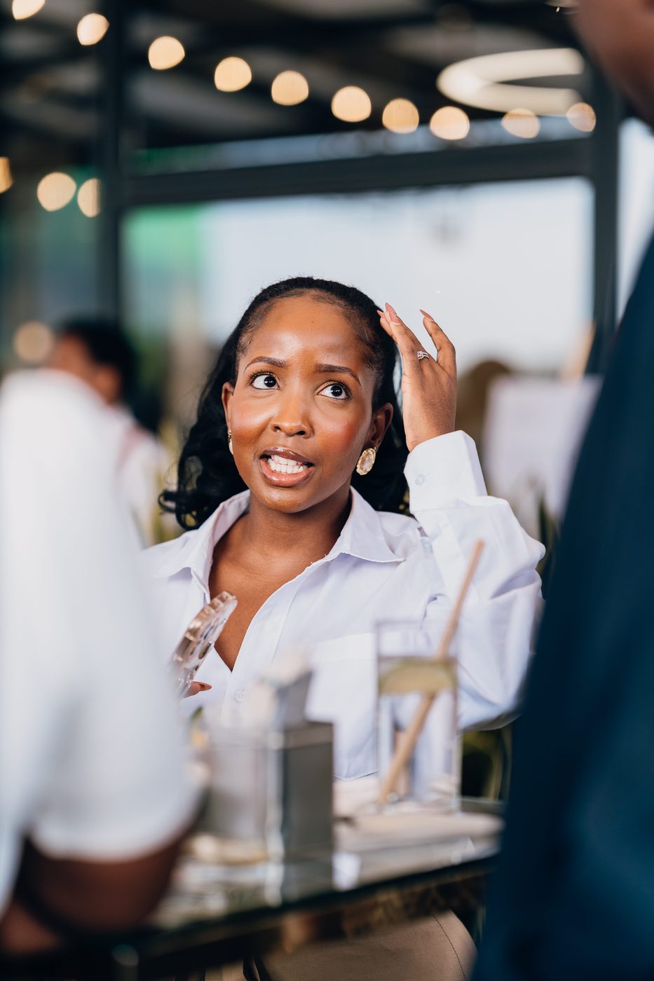 Portrait of a woman in a white shirt, gold earrings, daylight fading
