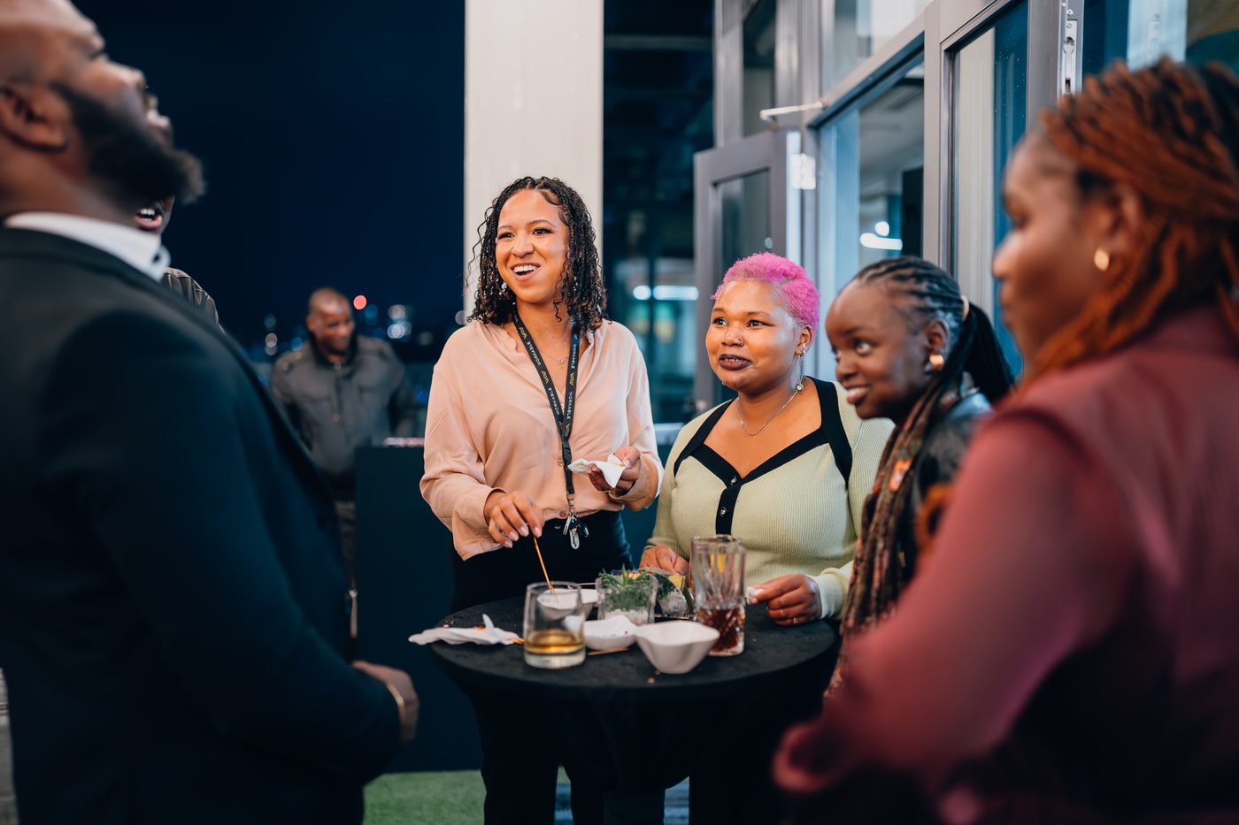 Group networking with drinks at evening event