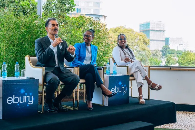 Wide shot of the panel with a speaker standing at the microphone