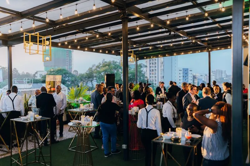 Evening networking under string lights on the terrace
