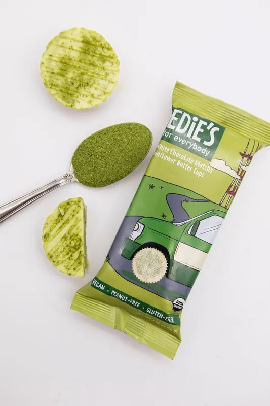 Edie's matcha pack from above with a spoon of matcha powder