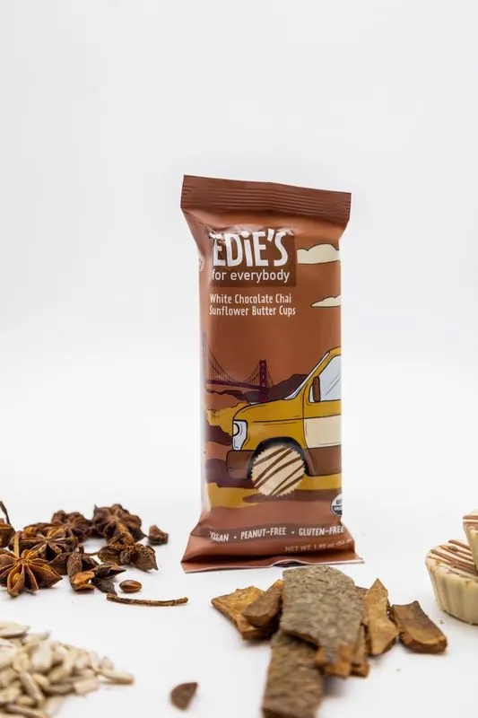Edie's chai pack standing among star anise, cinnamon and seeds