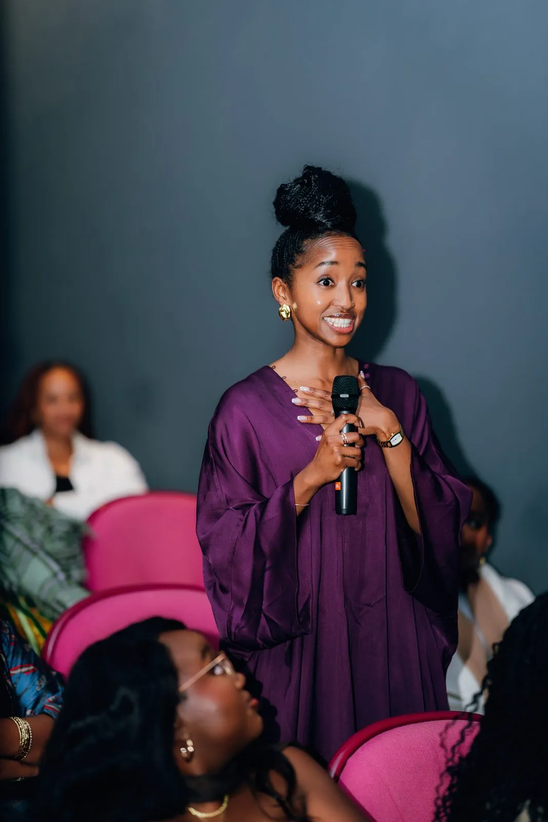 Guest in purple standing to speak in the cinema