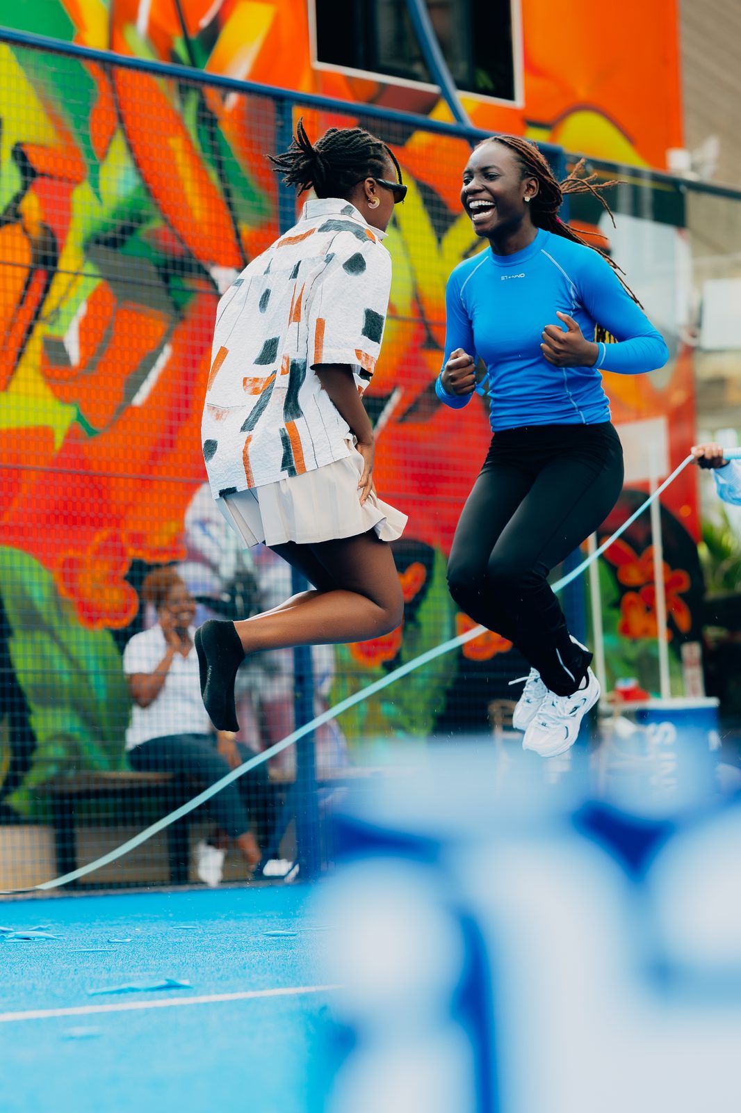 Two participants mid-jump during the rope routine