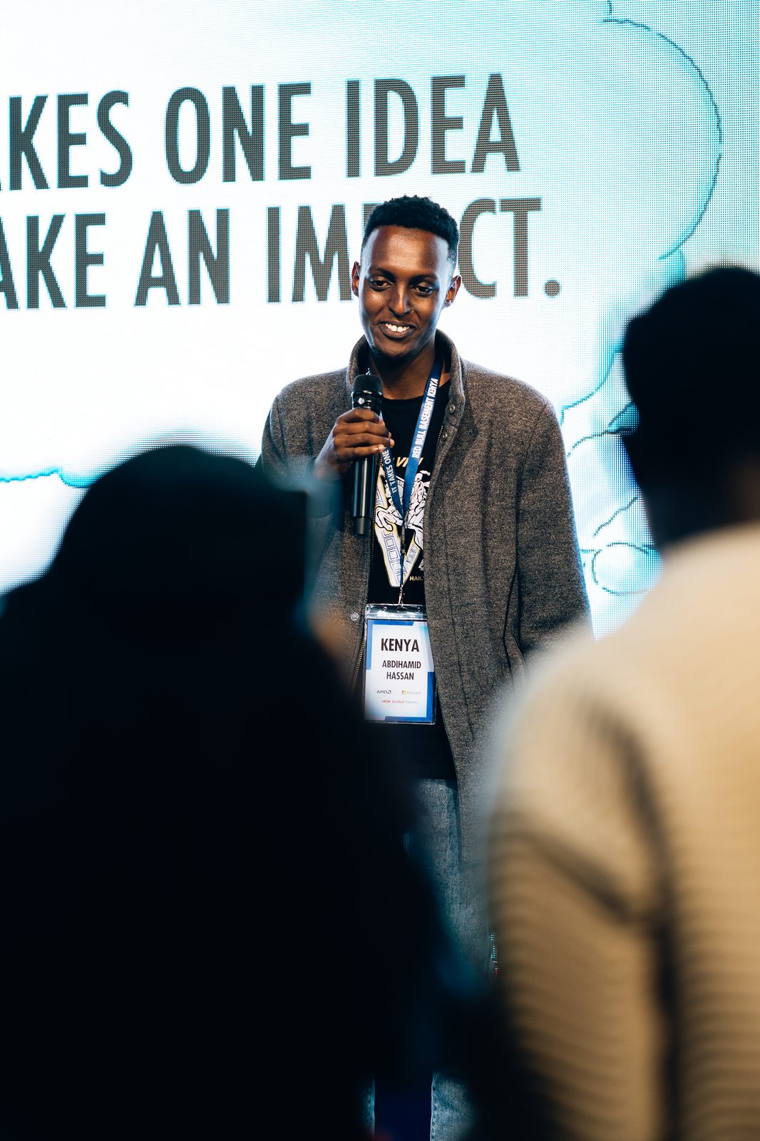 Abdihamid Hassan delivering his pitch with KENYA badge