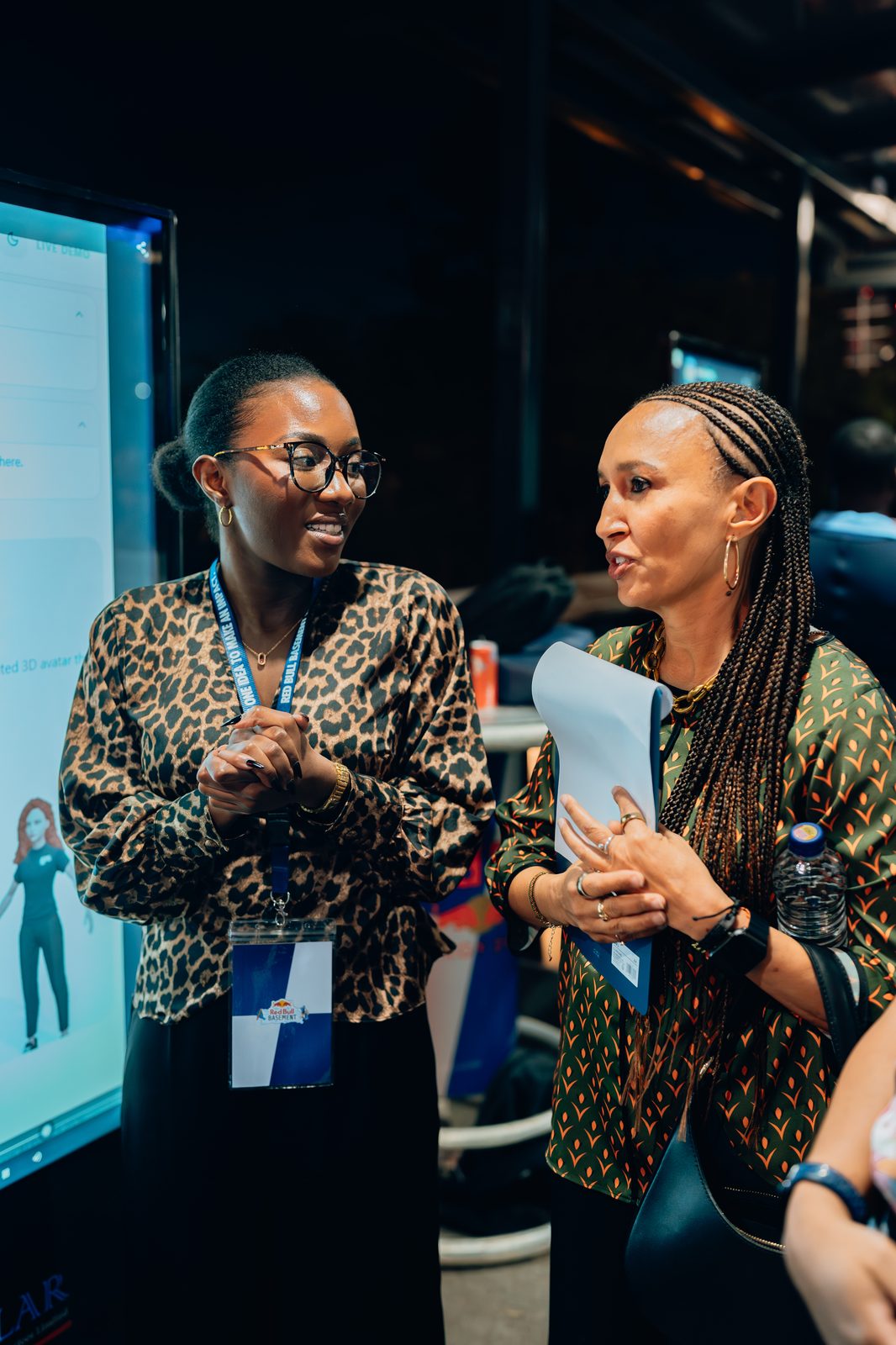 Two delegates leaning in during a networking moment