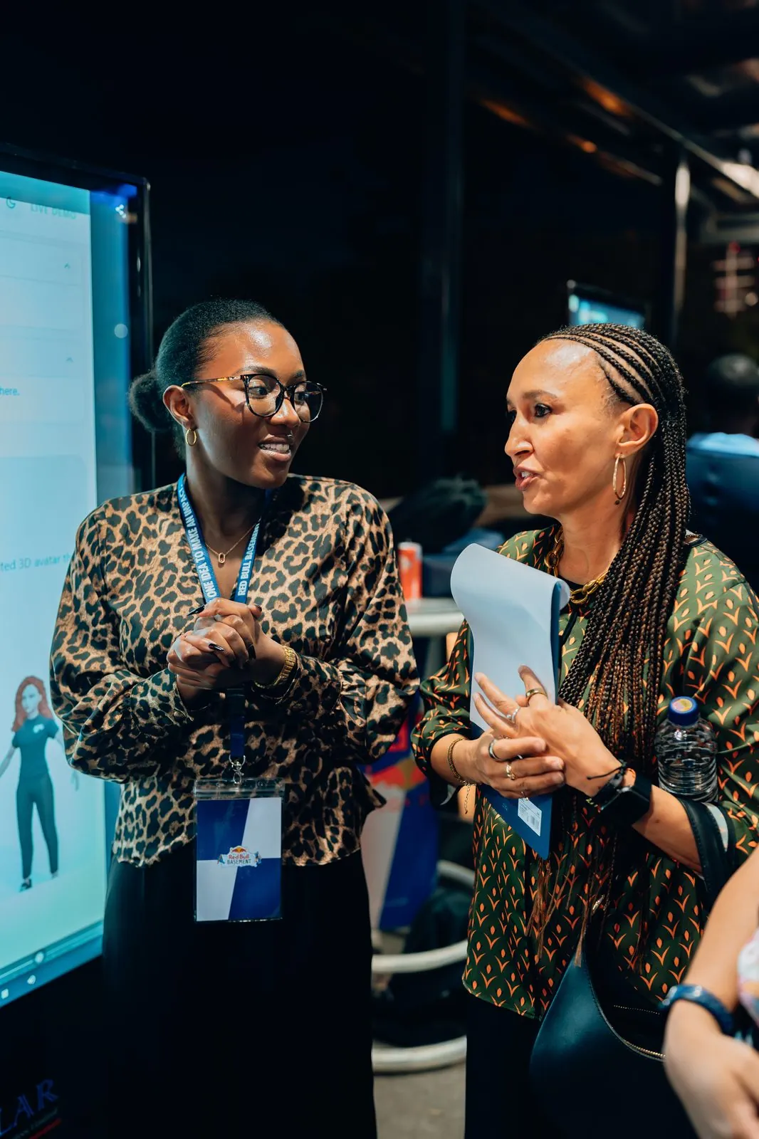 Two delegates leaning in during a networking moment