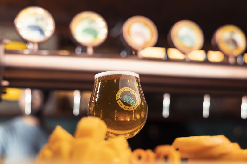 Beer glass with tap row in background