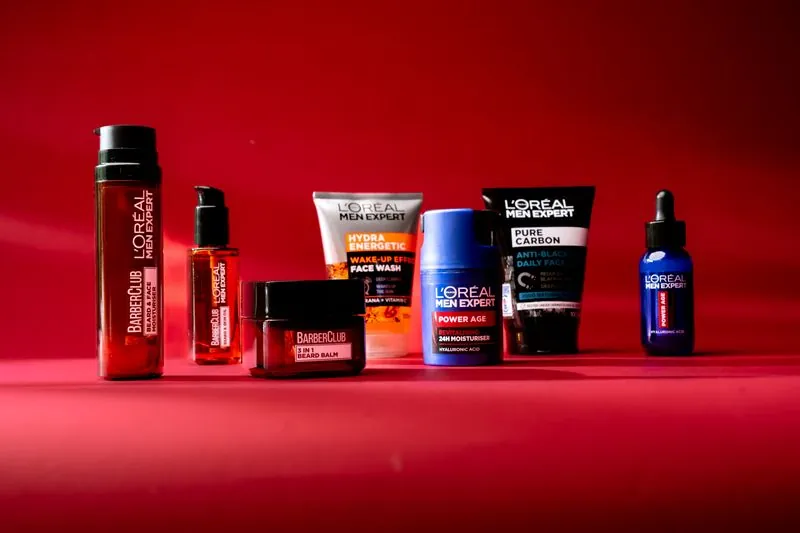 The L'Oréal Men Expert range lined up on a red studio sweep