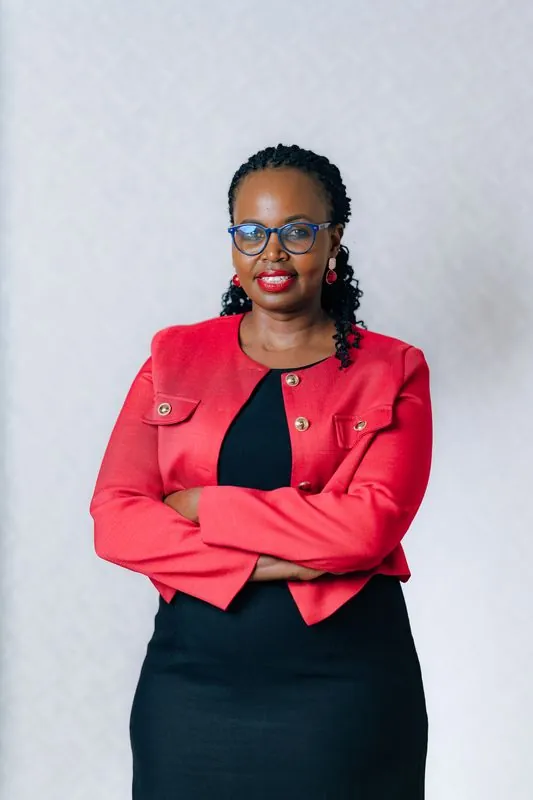 Corporate headshot against a pale grey backdrop
