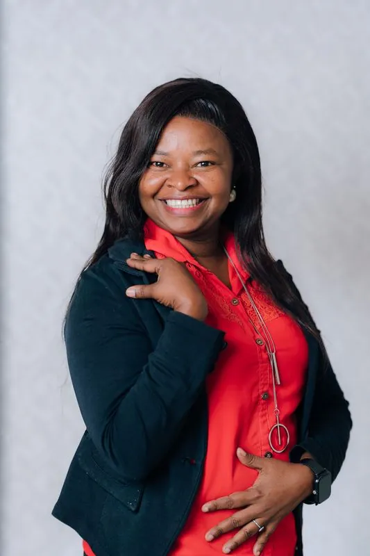 Corporate headshot against a pale grey backdrop