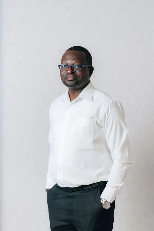 Corporate headshot against a pale grey backdrop