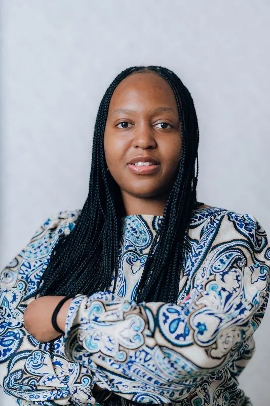 Corporate headshot against a pale grey backdrop