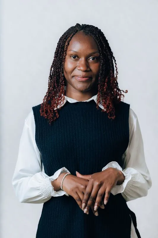 Corporate headshot against a pale grey backdrop