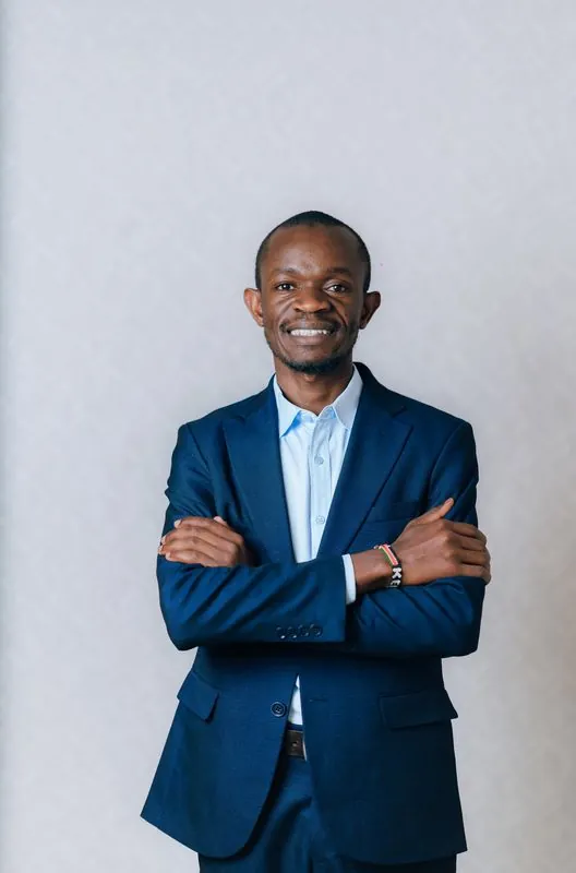 Corporate headshot against a pale grey backdrop