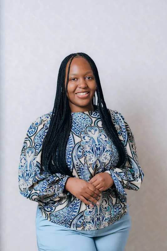 Corporate headshot against a pale grey backdrop