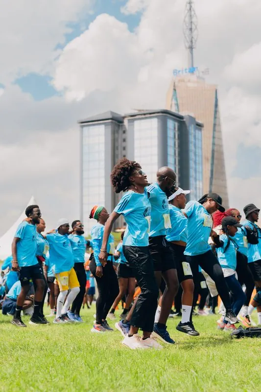 Runners warming up before the Wings for Life World Run with Britam Tower in the background